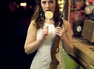 Bride holding a gun and lollypop