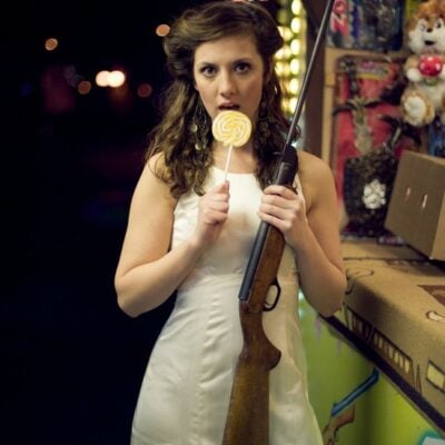 Bride holding a gun and lollypop