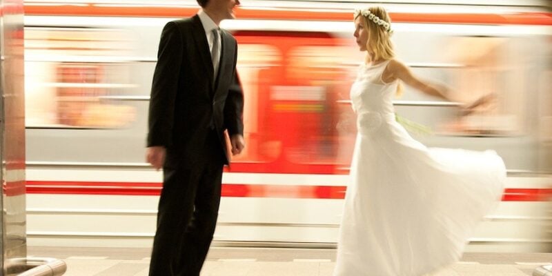 Bride and Groom next to a moving metro